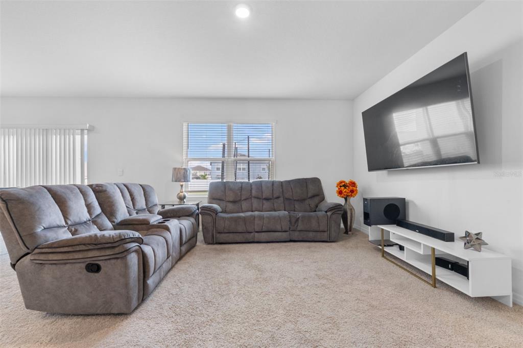 821 Sun Burst Road Winter Haven, FL 33880 - Photo 28 of 86 a living room with furniture and a flat screen tv