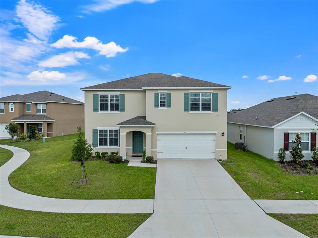 821 Sun Burst Road Winter Haven, FL 33880 - Photo 3 of 86 a front view of a house with a yard