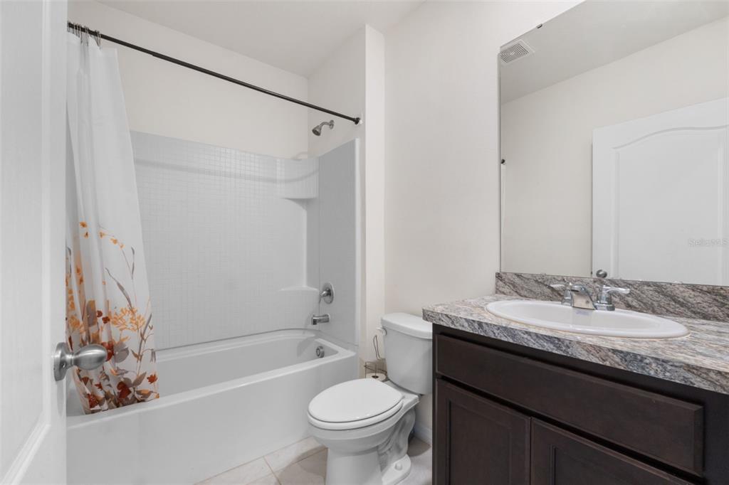 821 Sun Burst Road Winter Haven, FL 33880 - Photo 34 of 86 a bathroom with a granite countertop sink toilet and shower