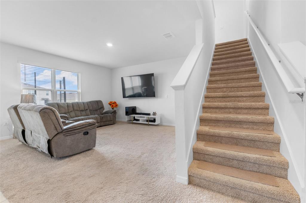 821 Sun Burst Road Winter Haven, FL 33880 - Photo 36 of 86 a living room with furniture and a stairs