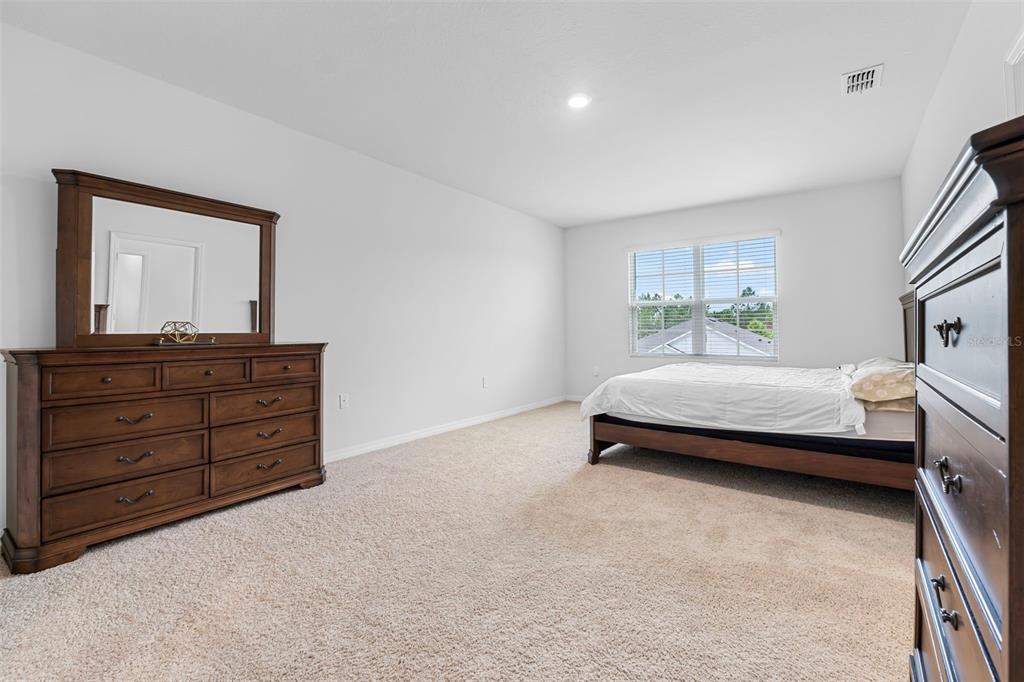 821 Sun Burst Road Winter Haven, FL 33880 - Photo 39 of 86 a bedroom with a bed and a dresser