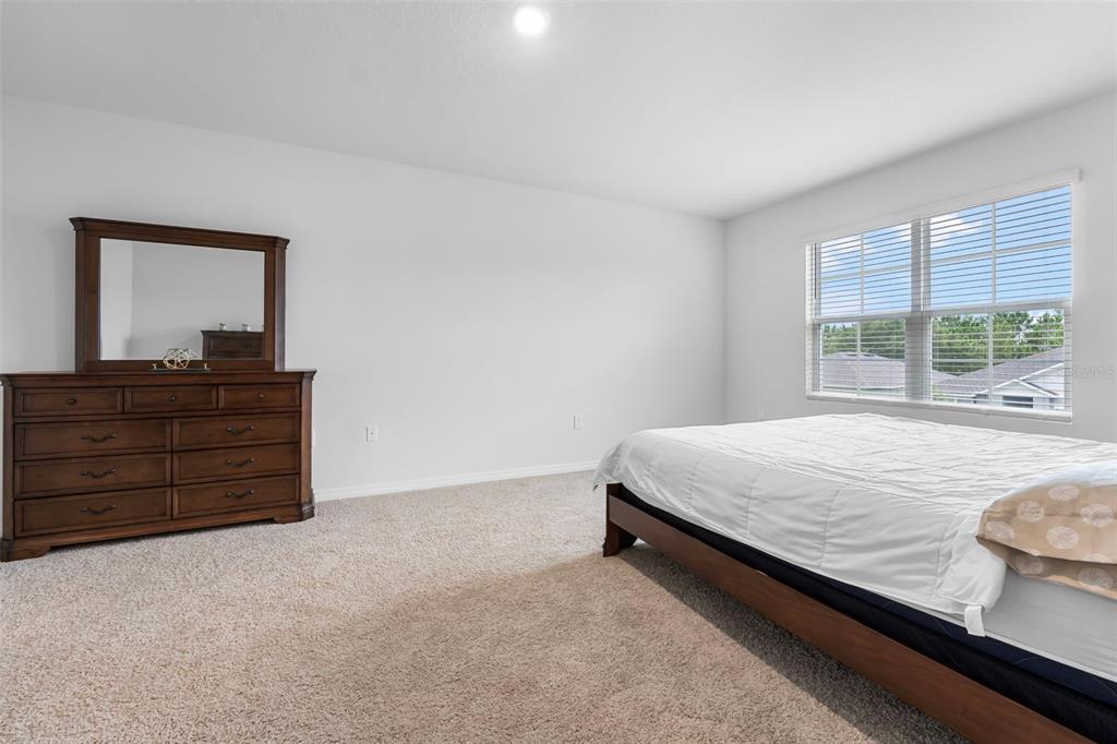 821 Sun Burst Road Winter Haven, FL 33880 - Photo 40 of 86 a bed sitting in a bedroom next to a window