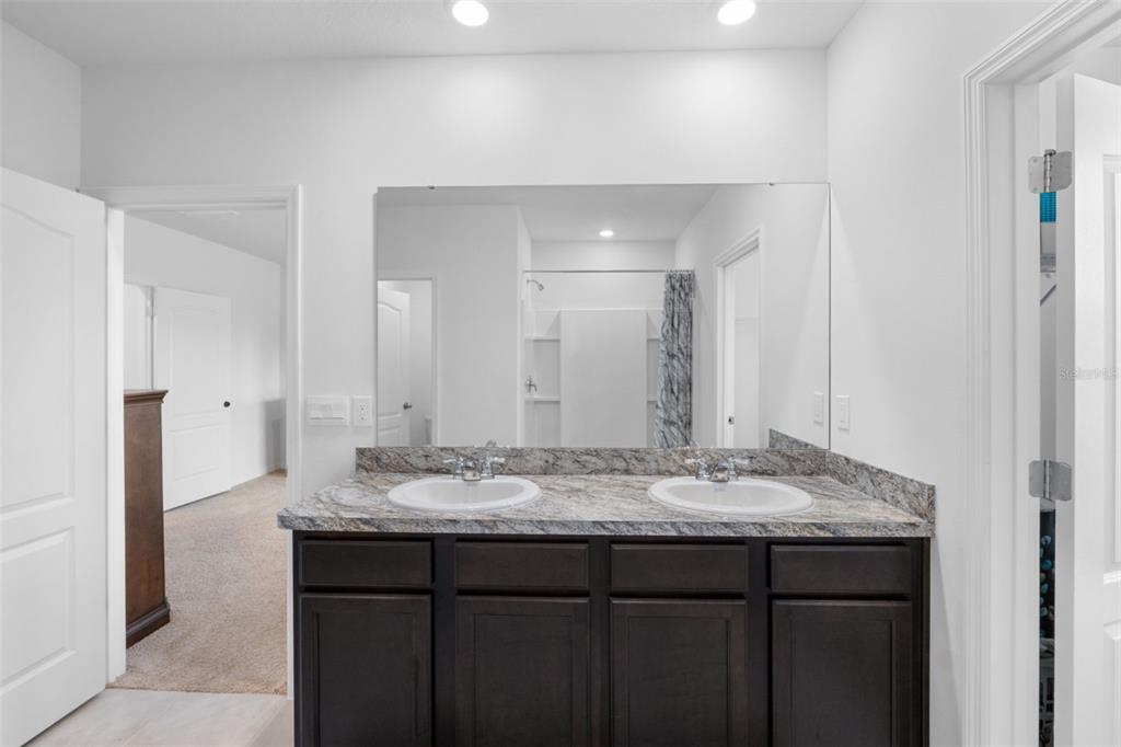 821 Sun Burst Road Winter Haven, FL 33880 - Photo 44 of 86 a bathroom with a granite countertop sink and a mirror