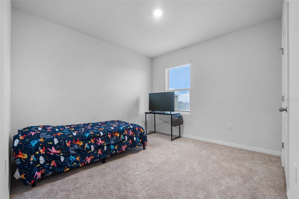 821 Sun Burst Road Winter Haven, FL 33880 - Photo 57 of 86 a bedroom with a bed and a television in it