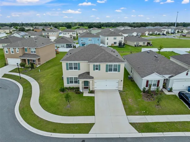 a aerial view of a house with a garden and trees