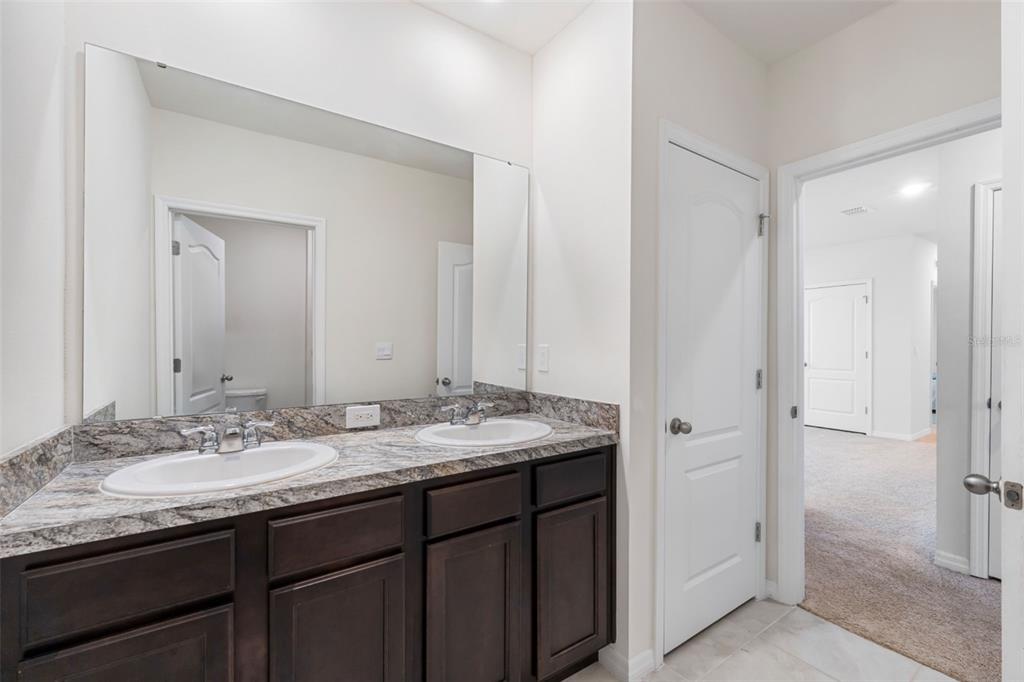821 Sun Burst Road Winter Haven, FL 33880 - Photo 61 of 86 a bathroom with a granite countertop sink and a mirror
