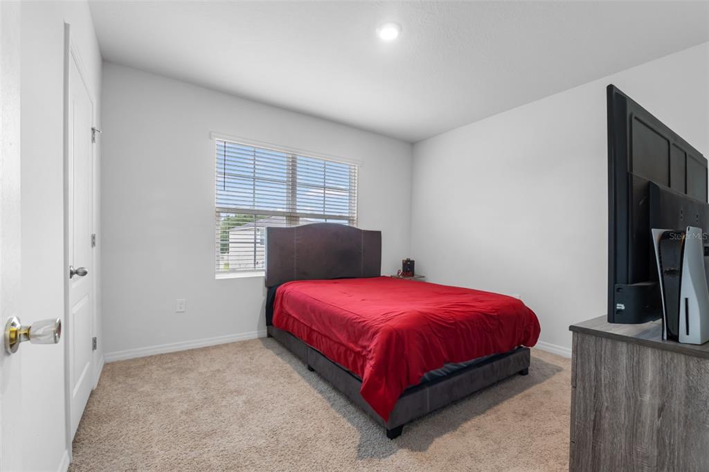 821 Sun Burst Road Winter Haven, FL 33880 - Photo 65 of 86 a bedroom with a bed and a flat screen tv
