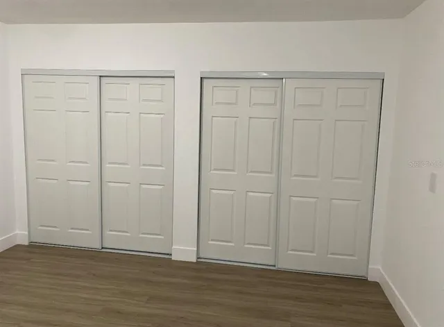 a kitchen with a refrigerator and a stove top oven