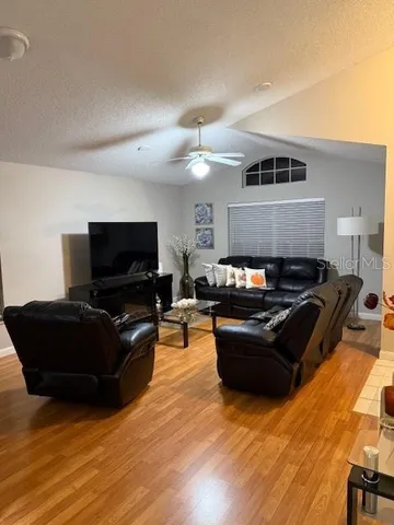 a living room with furniture and a flat screen tv