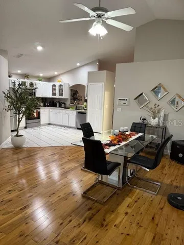 a living room with lots of furniture and kitchen view
