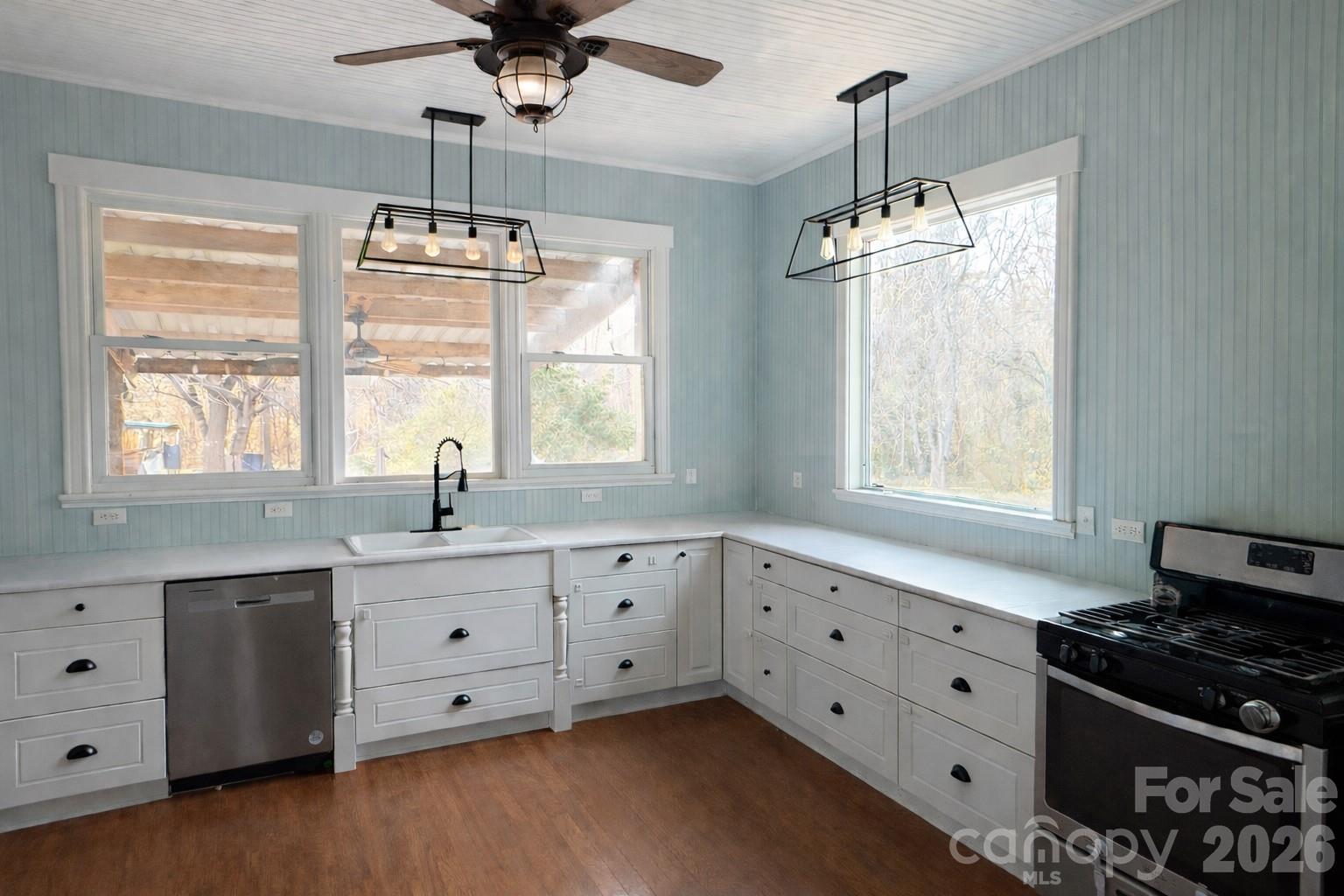 129 11th Street Spencer, NC 28159 - Photo 4 of 22 a kitchen with granite countertop a stove a sink and a window