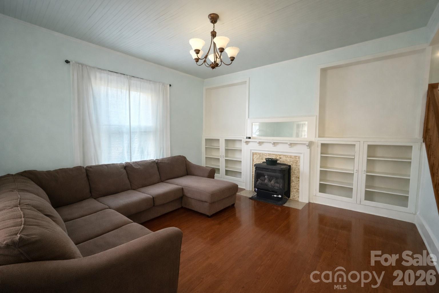 129 11th Street Spencer, NC 28159 - Photo 7 of 22 a living room with furniture a fireplace and a chandelier