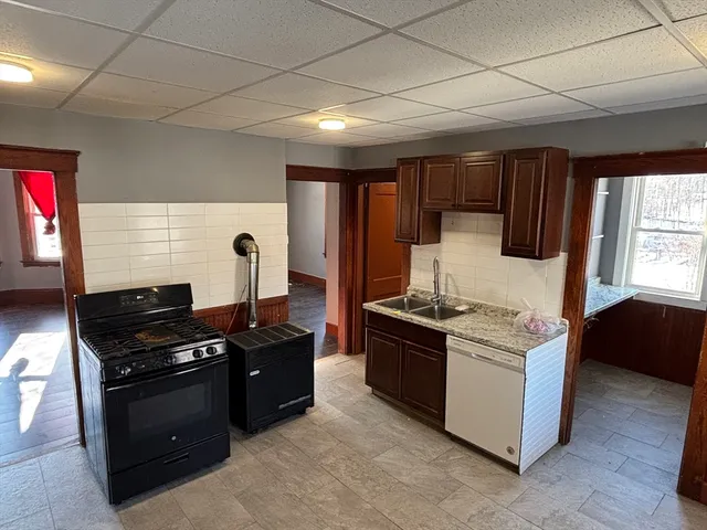a kitchen with stainless steel appliances granite countertop a stove and a refrigerator