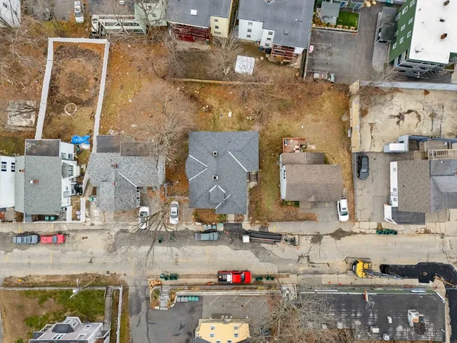 an aerial view of residential houses with outdoor space