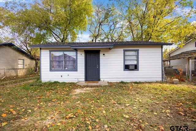 a house with a tree in front of it