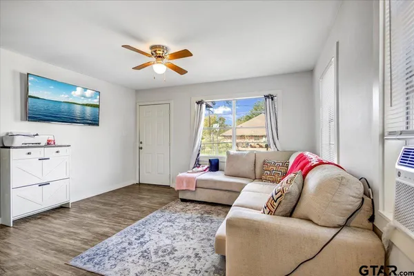 a living room with furniture and a flat screen tv