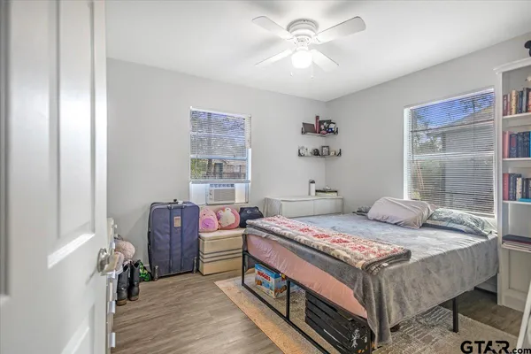 a bedroom with a bed and a chandelier