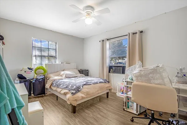 a bedroom with a bed and windows