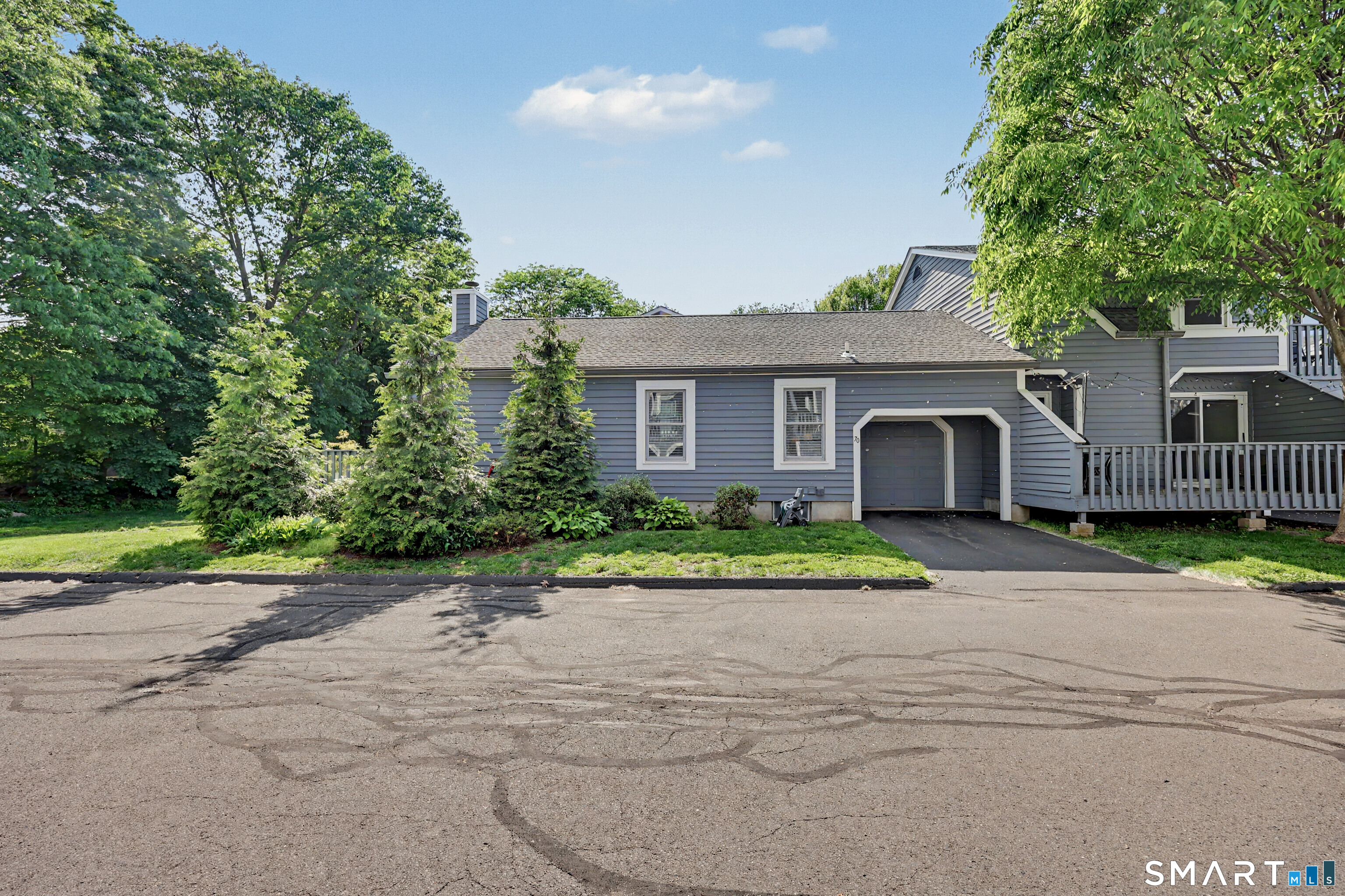 70 Fawn Ridge Lane, Unit 70 Norwalk, CT 06851 - Photo 26 of 36 a front view of a house with a yard and a garage