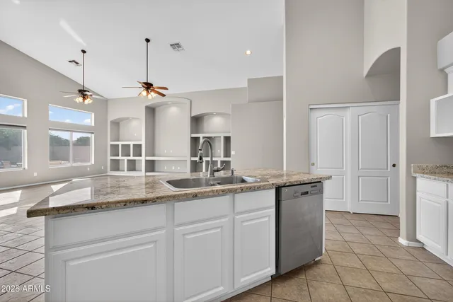 a kitchen with a sink counter top space and cabinets