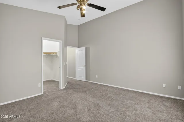 an empty room with a empty space and a ceiling fan