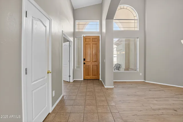a view of a hallway with wooden floor and a bathroom
