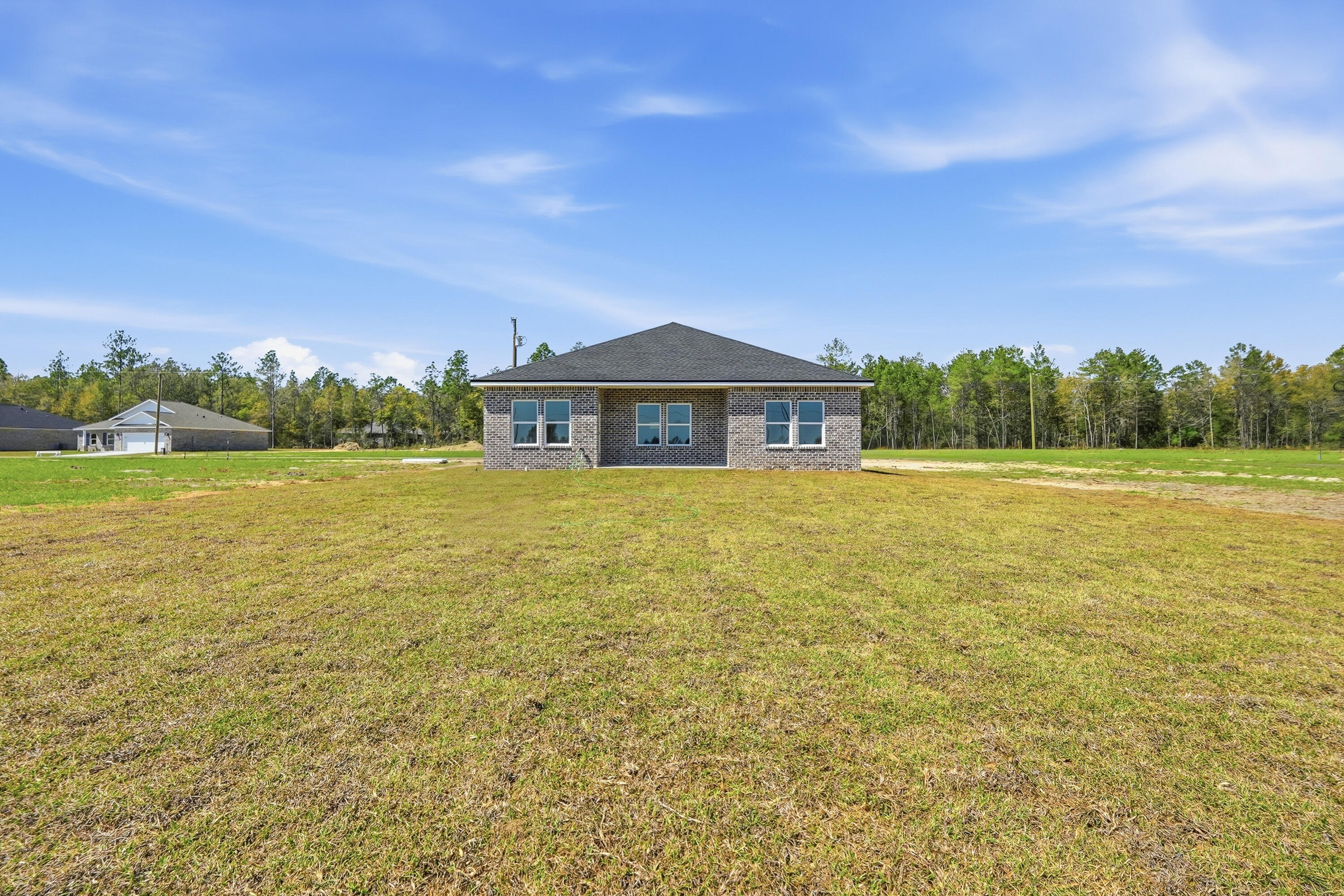 6114 Mildreds Way Crestview, FL 32539 - Photo 23 of 24 a view of a large body of water with a building in the background