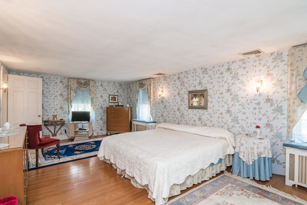 32 Longview Drive Longmeadow, MA 01106 - Photo 21 of 42 a spacious bedroom with a bed and wooden floor