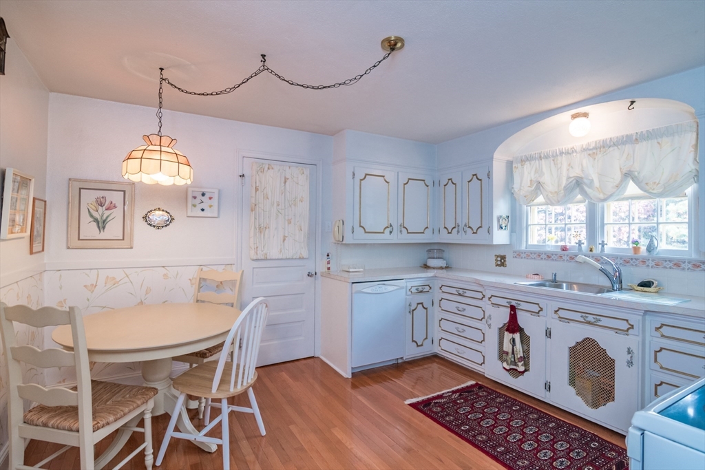 32 Longview Drive Longmeadow, MA 01106 - Photo 5 of 42 a kitchen with stainless steel appliances granite countertop a sink a stove a dining table and chairs