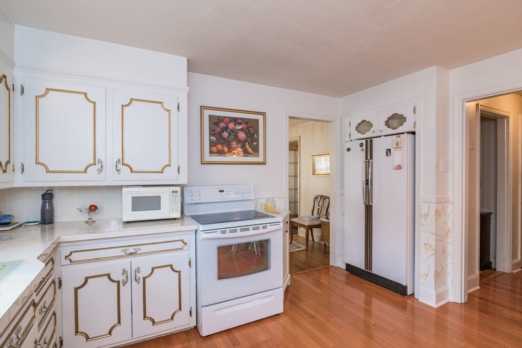 32 Longview Drive Longmeadow, MA 01106 - Photo 6 of 42 a kitchen with stainless steel appliances granite countertop a stove a refrigerator and a wooden floor