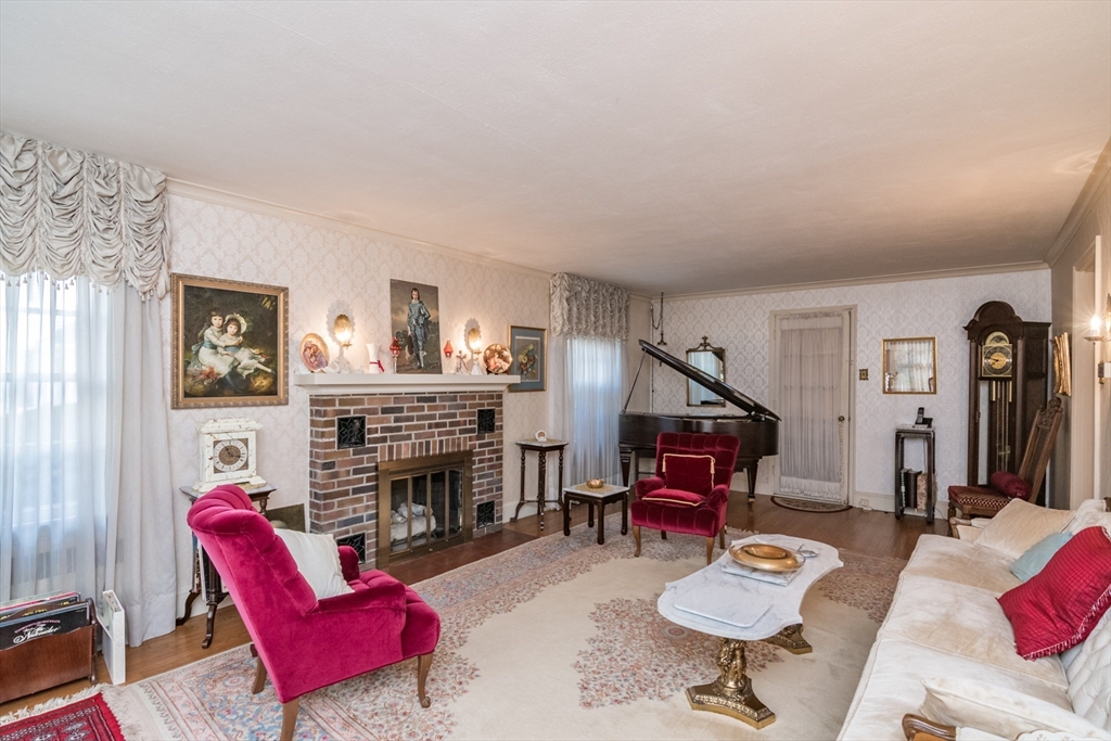 32 Longview Drive Longmeadow, MA 01106 - Photo 8 of 42 a living room with furniture a fireplace and a flat screen tv