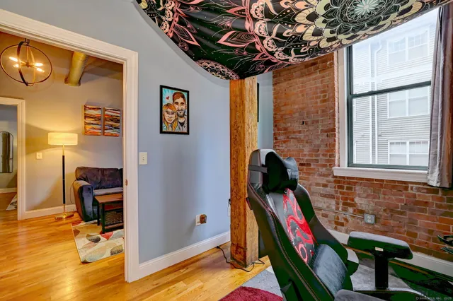a bathroom with a granite countertop toilet sink and mirror