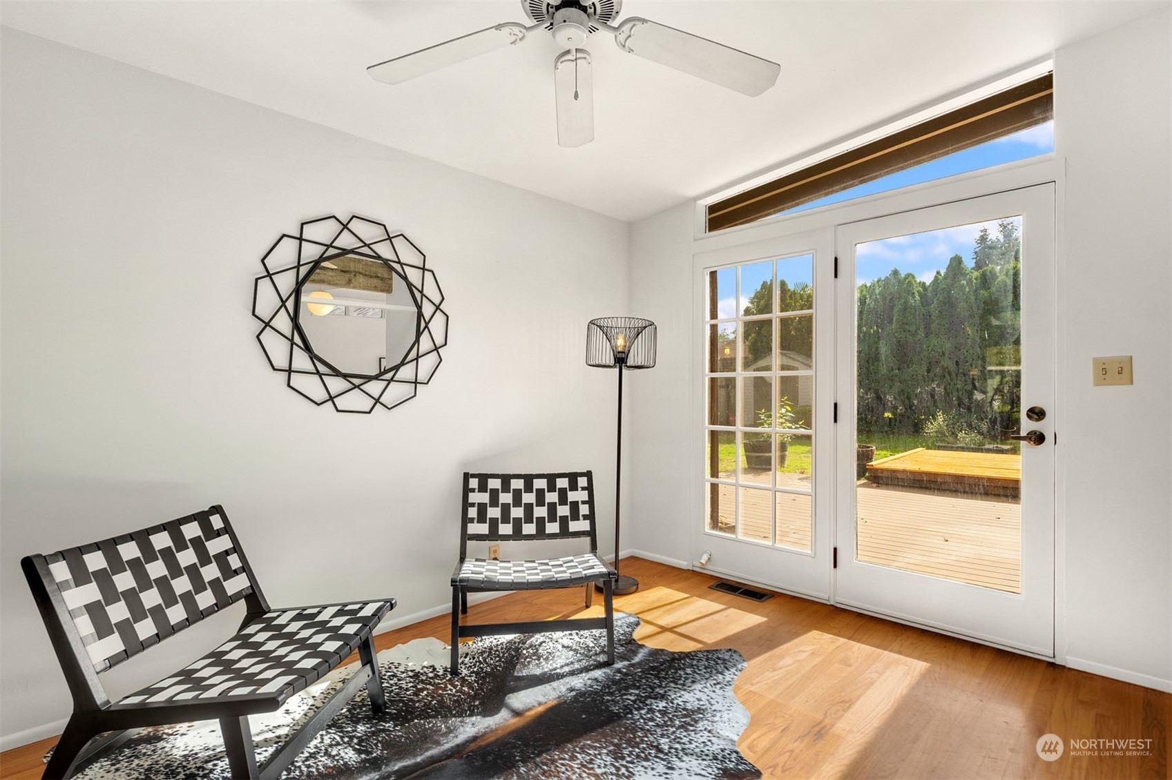 15040 131st Avenue Southeast Renton, WA 98058 - Photo 6 of 39 a view of an empty room with a window and wooden floor
