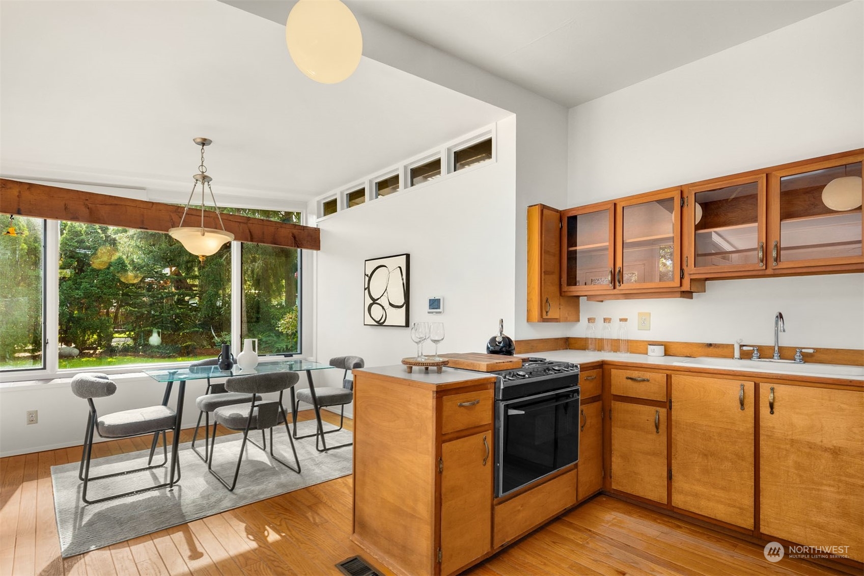 15040 131st Avenue Southeast Renton, WA 98058 - Photo 10 of 39 a kitchen with a stove a sink a dining table and chairs