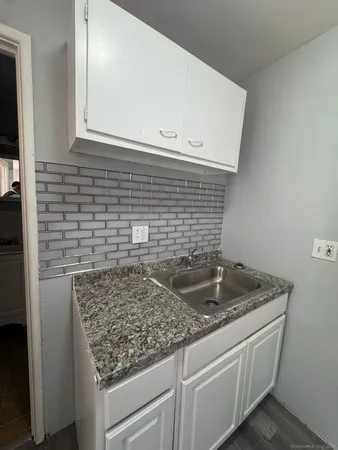 a view of kitchen island sink and refrigerator