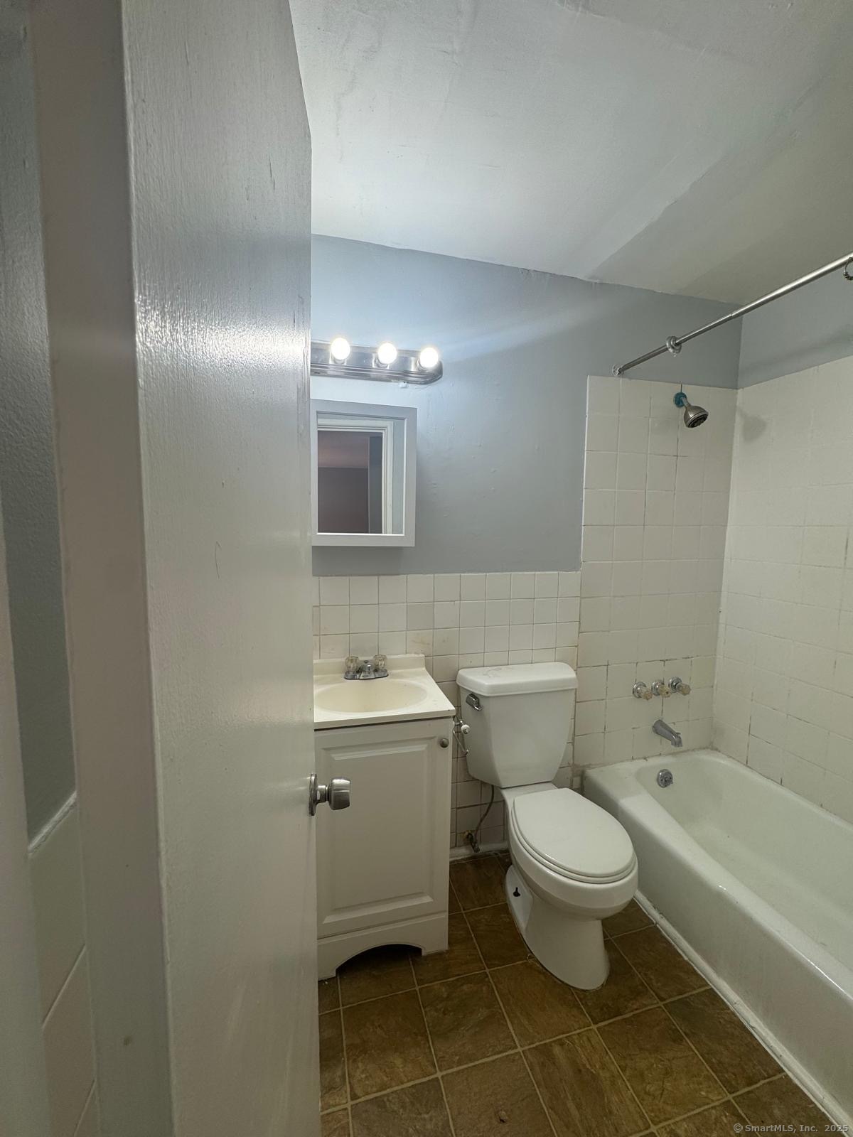 404 Charles Street, Unit B2 Bridgeport, CT 06606 - Photo 6 of 9 a bathroom with a toilet sink and mirror