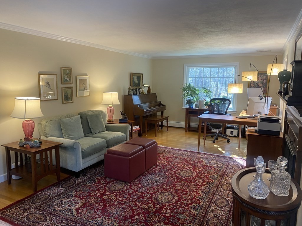 126 Maynard Farm Road Sudbury, MA 01776 - Photo 11 of 32 a living room with furniture a rug and a lamp