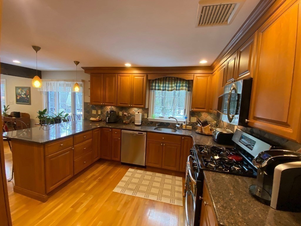 126 Maynard Farm Road Sudbury, MA 01776 - Photo 3 of 32 a kitchen with stainless steel appliances granite countertop sink stove and refrigerator