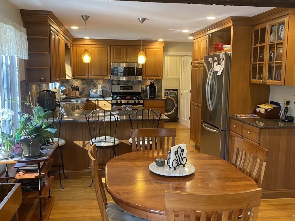 126 Maynard Farm Road Sudbury, MA 01776 - Photo 4 of 32 a kitchen with a table and chairs
