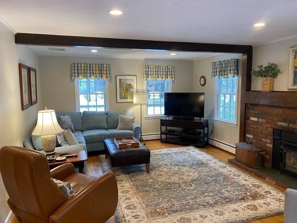 126 Maynard Farm Road Sudbury, MA 01776 - Photo 8 of 32 a living room with furniture and a flat screen tv
