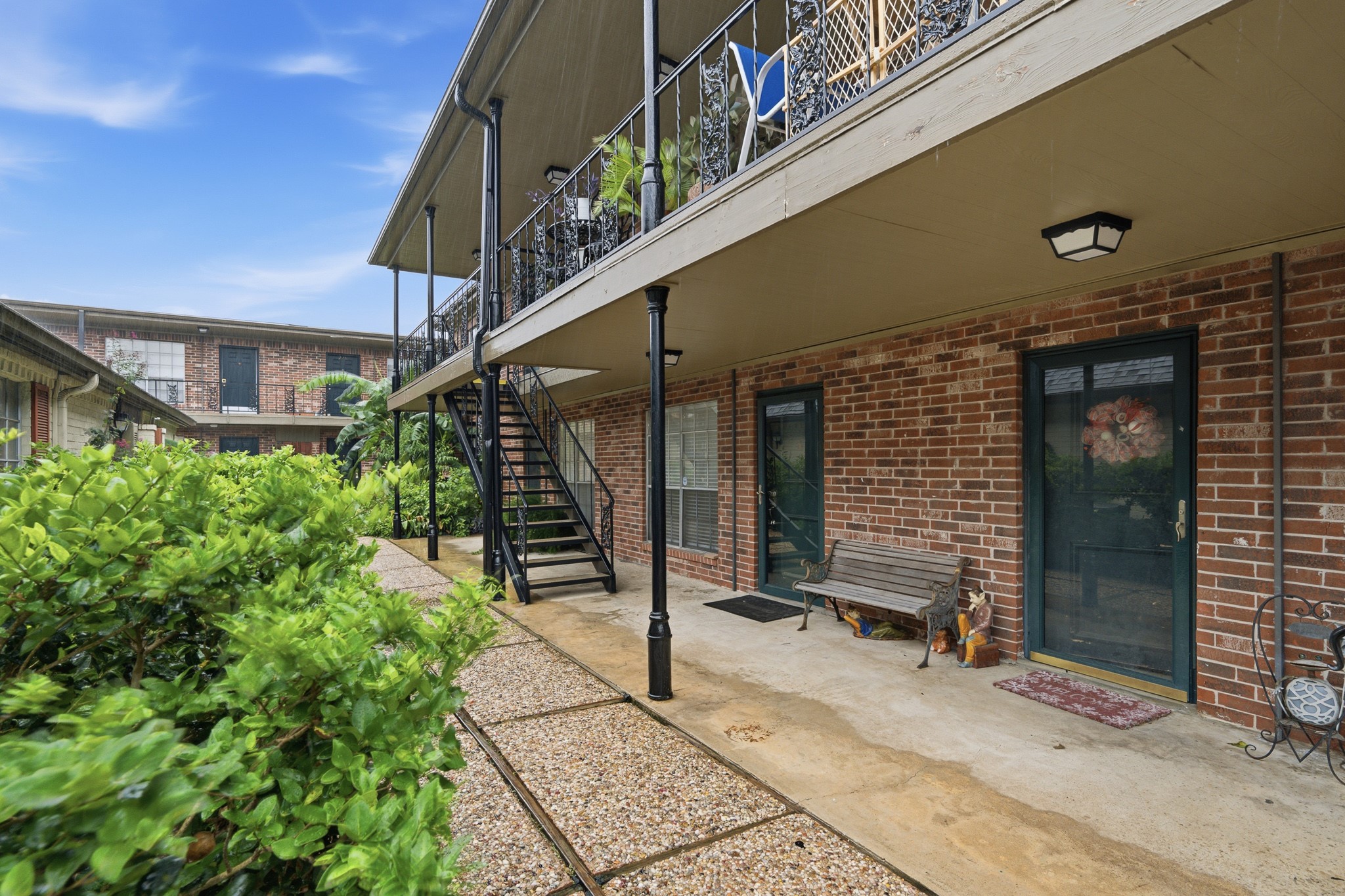 11550 Chimney Rock Road, Unit 133 Houston, TX 77035 - Photo 23 of 40 Charming brick exterior with a welcoming patio area, offering a cozy outdoor space.