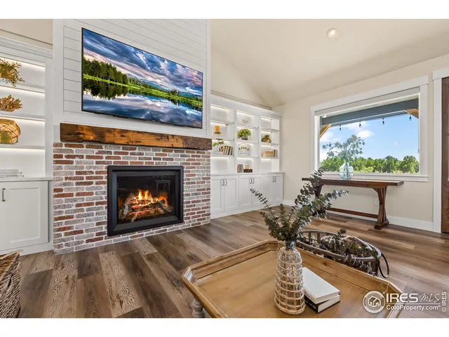 a dining room with wooden floor a chandelier a wooden table and chairs