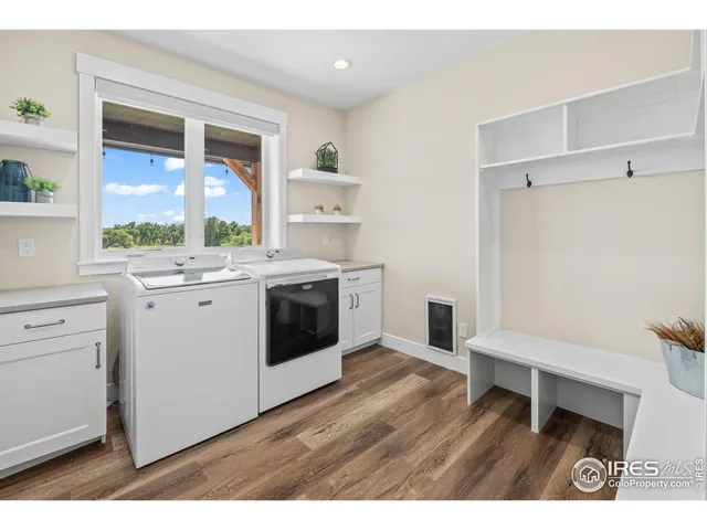 a bedroom with furniture and a large window