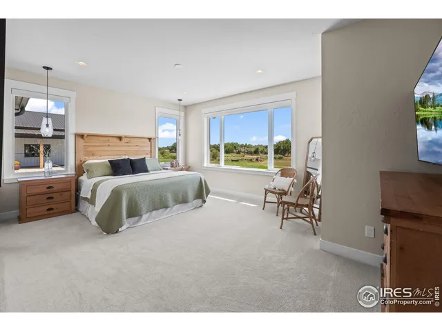 a bed room with a bed and a chair