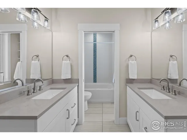 a bathroom with a sink a toilet and vanity