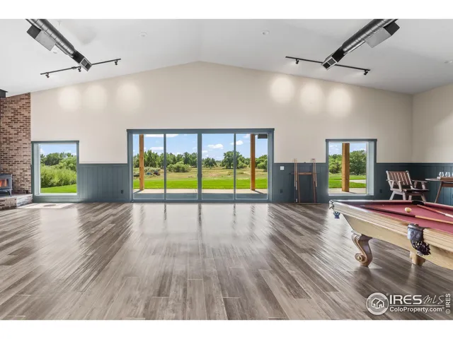 a living room with lots of furniture and kitchen view