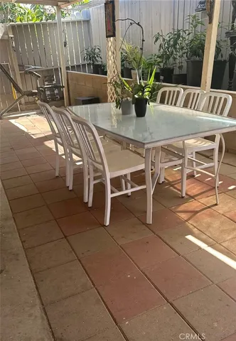 a view of outdoor dining space with a table and chairs