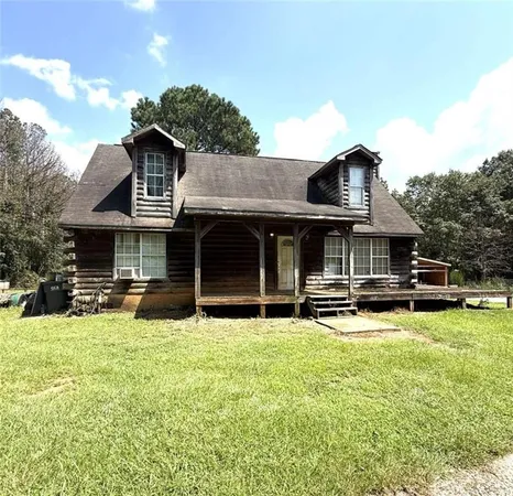 a front view of a house with yard and porch