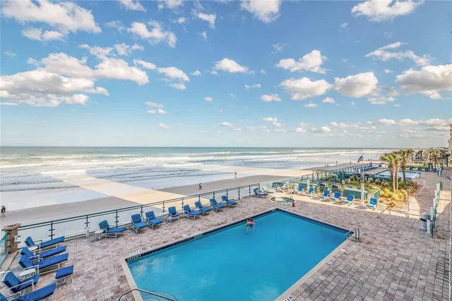 a kitchen with stainless steel appliances granite countertop a sink a stove a microwave and wooden cabinets
