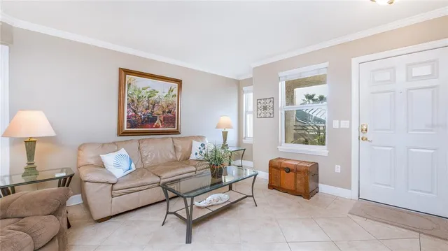 a living room with furniture and a refrigerator